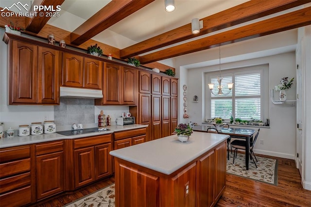 kitchen featuring a kitchen island, dark hardwood / wood-style floors, backsplash, hanging light fixtures, and beam ceiling