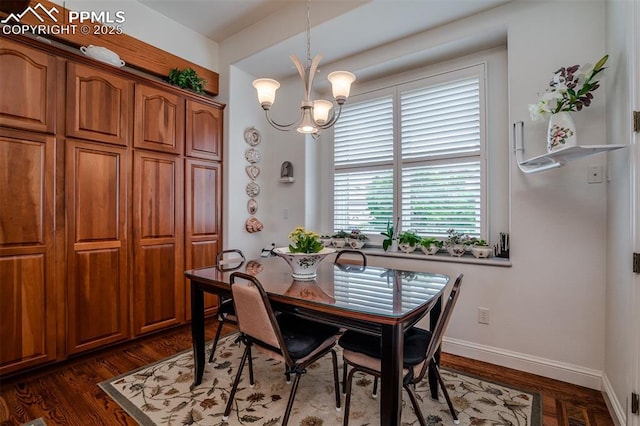 dining space with dark hardwood / wood-style floors and a notable chandelier