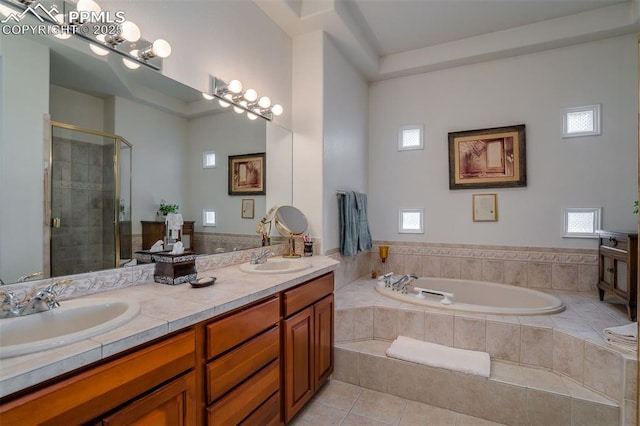 bathroom featuring vanity, shower with separate bathtub, and tile patterned floors