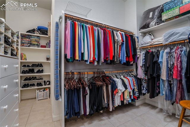 walk in closet with tile patterned floors