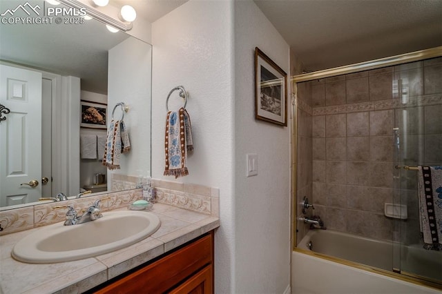 bathroom with vanity and bath / shower combo with glass door