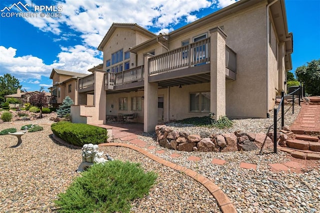 back of house featuring a patio and a balcony