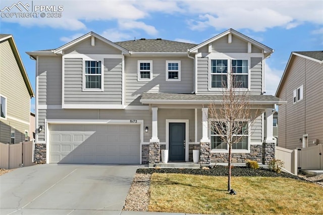 view of front of home with a garage, covered porch, and a front yard