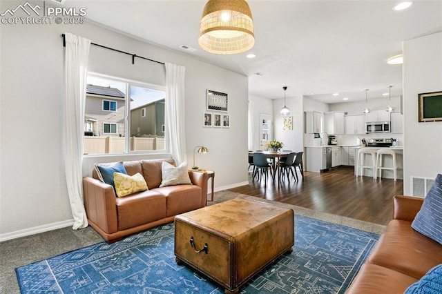 living room with dark hardwood / wood-style flooring and plenty of natural light