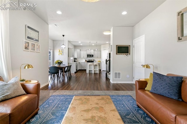 living room with dark hardwood / wood-style flooring