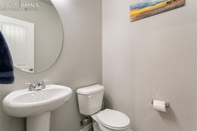 bathroom with toilet and sink