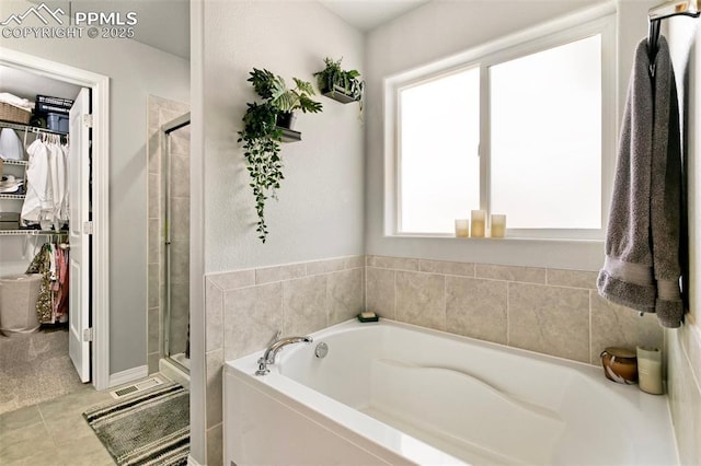 bathroom with tile patterned flooring and plus walk in shower