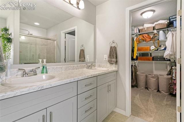 bathroom featuring vanity, an enclosed shower, and tile patterned floors