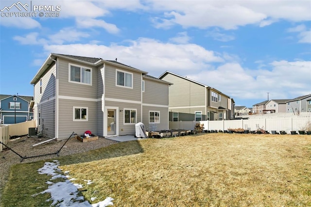 back of house featuring central AC unit and a lawn