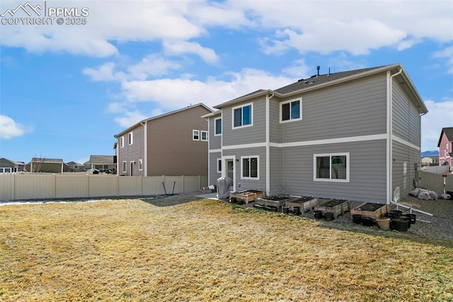 rear view of property featuring a yard