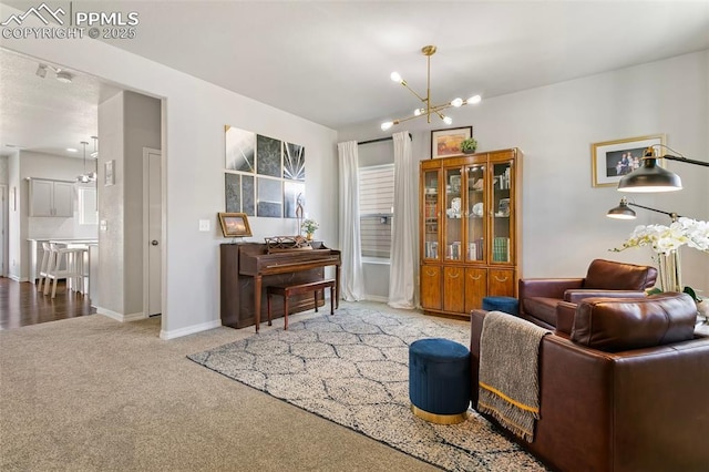 living area featuring carpet floors and a notable chandelier