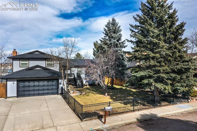 view of front of property with a garage and a front lawn