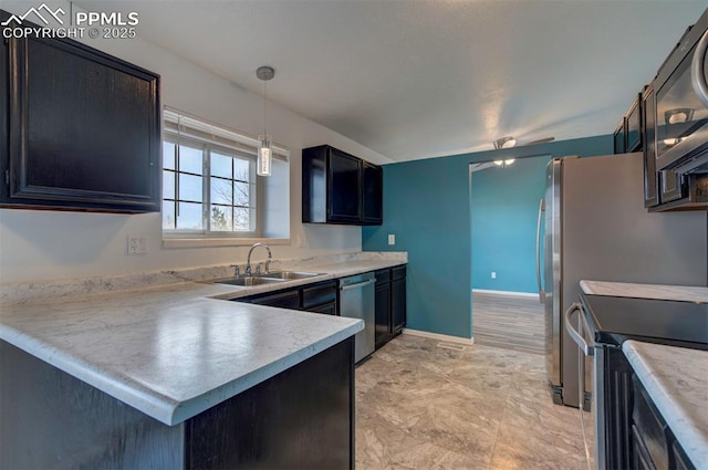 kitchen featuring appliances with stainless steel finishes, kitchen peninsula, sink, and hanging light fixtures