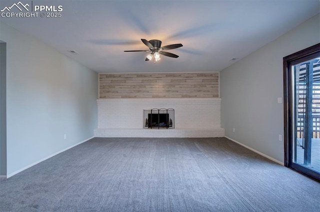 unfurnished living room featuring carpet, ceiling fan, and a brick fireplace