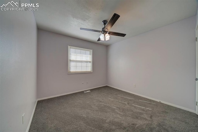 empty room featuring ceiling fan and dark carpet