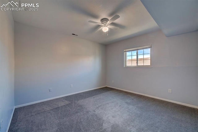 spare room featuring ceiling fan and dark carpet