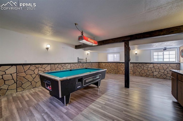 recreation room featuring beamed ceiling, billiards, light hardwood / wood-style floors, and a textured ceiling