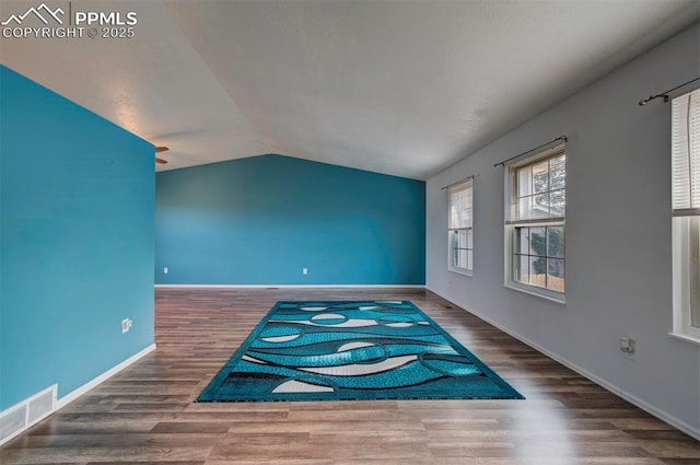 interior space with lofted ceiling and dark wood-type flooring