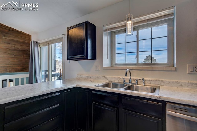 kitchen with dishwasher, lofted ceiling, sink, and decorative light fixtures