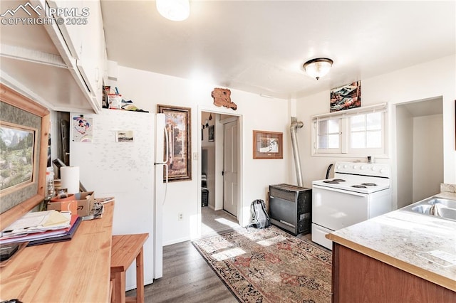 kitchen with dark wood-type flooring, sink, and white appliances