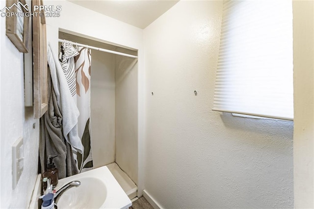 bathroom featuring sink and a shower with shower curtain