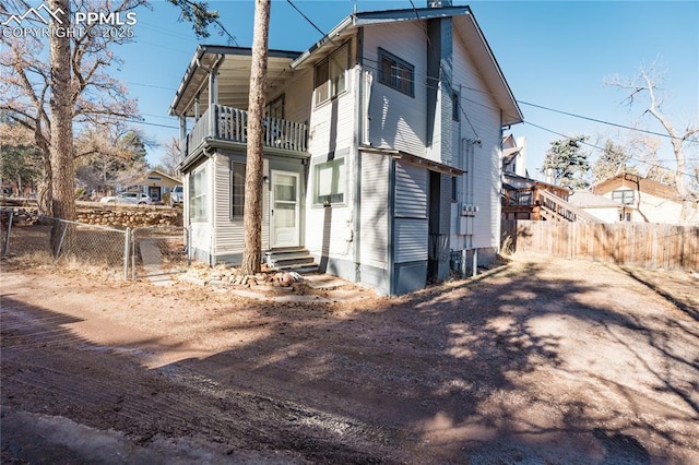 back of house featuring a balcony