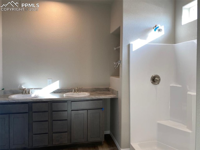 bathroom featuring vanity and a shower