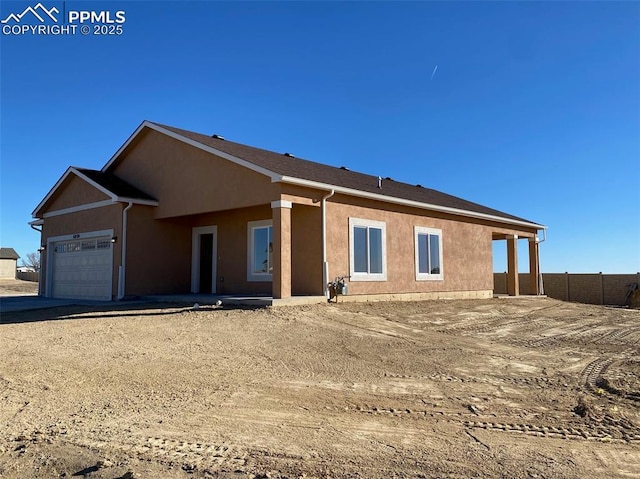 rear view of house featuring a garage