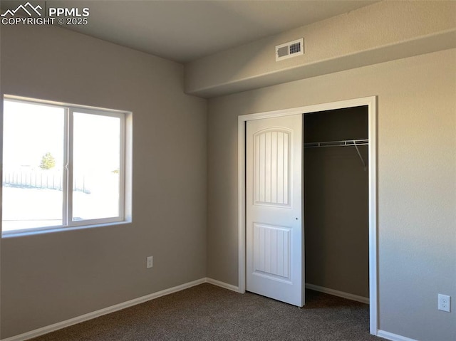 unfurnished bedroom featuring a closet and carpet