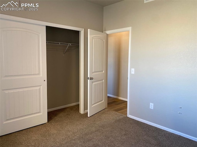 unfurnished bedroom with a closet and carpet flooring