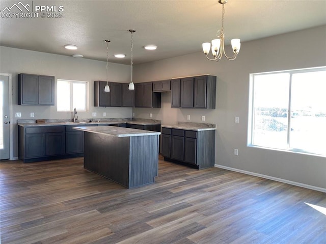 kitchen featuring a center island, pendant lighting, and dark wood-type flooring