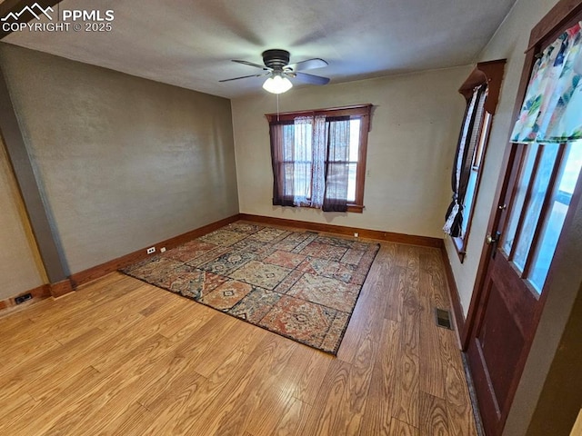 spare room with ceiling fan and light wood-type flooring