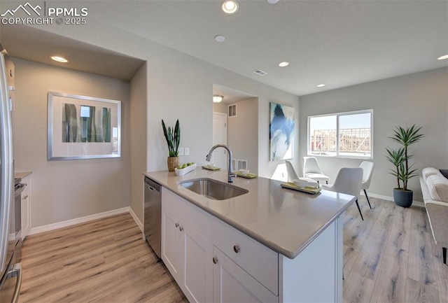 kitchen featuring sink, white cabinetry, light wood-type flooring, dishwasher, and kitchen peninsula