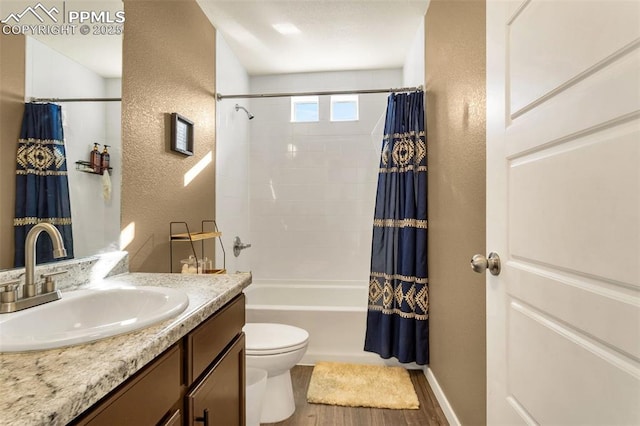 full bathroom featuring shower / tub combo with curtain, vanity, hardwood / wood-style flooring, and toilet