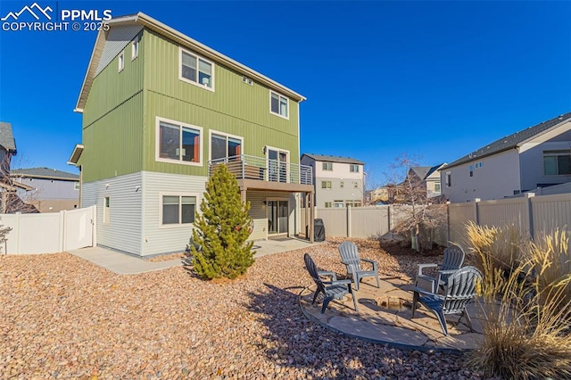 back of property with a patio and a balcony