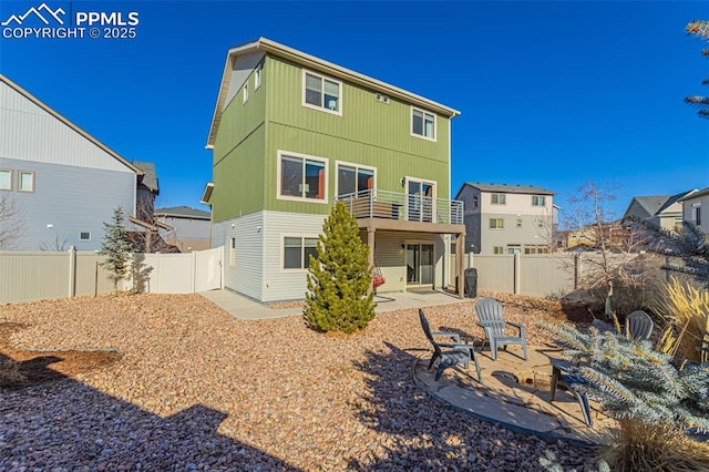 back of property featuring a patio area and a balcony