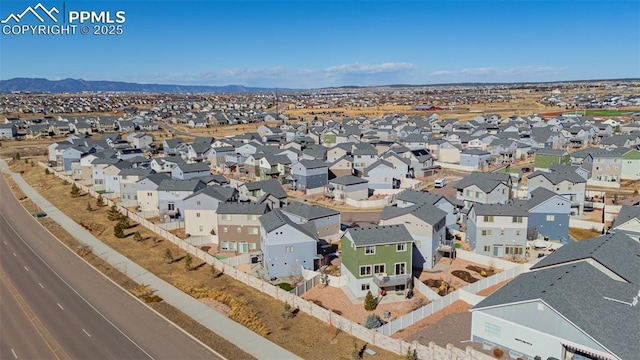 birds eye view of property with a mountain view