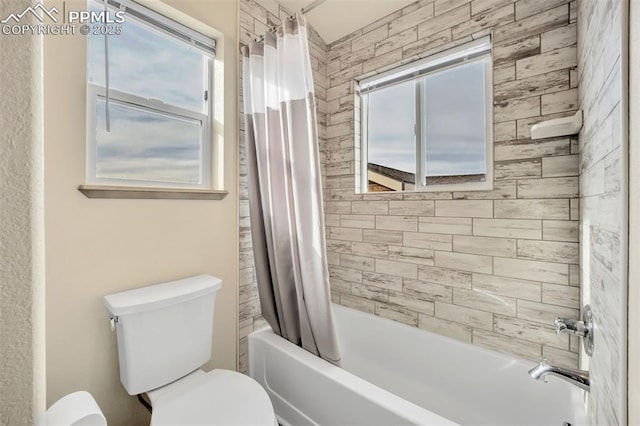 bathroom featuring toilet and shower / bath combo