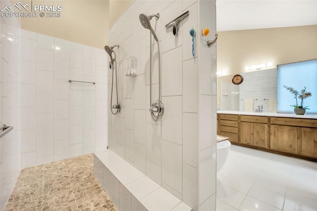 bathroom featuring vanity, tile patterned floors, and a tile shower