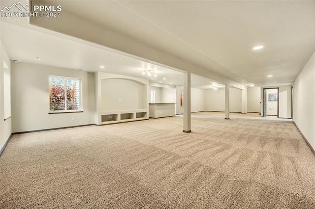 basement featuring light colored carpet