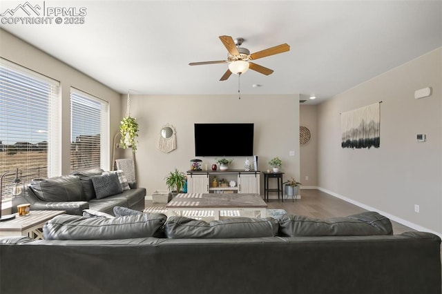 living room featuring wood-type flooring and ceiling fan