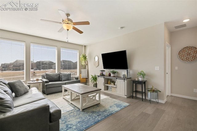 living room with ceiling fan and light wood-type flooring