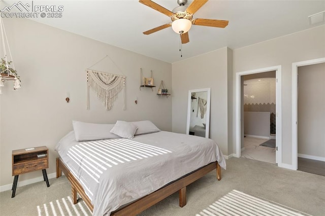 carpeted bedroom featuring ensuite bath and ceiling fan