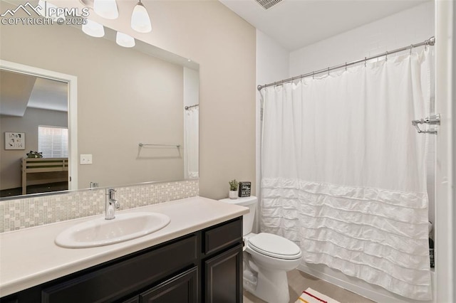 full bathroom with vanity, shower / tub combo, backsplash, and toilet