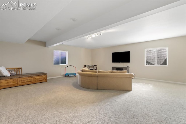 living room with plenty of natural light, carpet floors, and beam ceiling