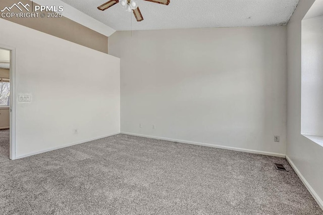 carpeted empty room with a textured ceiling, visible vents, baseboards, vaulted ceiling, and a ceiling fan