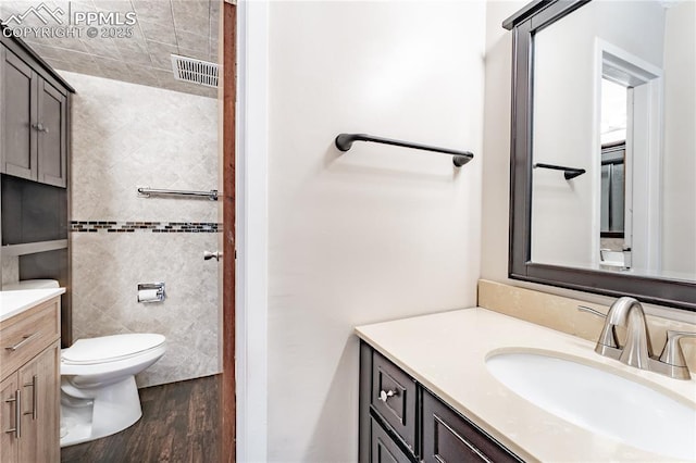 bathroom with vanity, hardwood / wood-style floors, and toilet