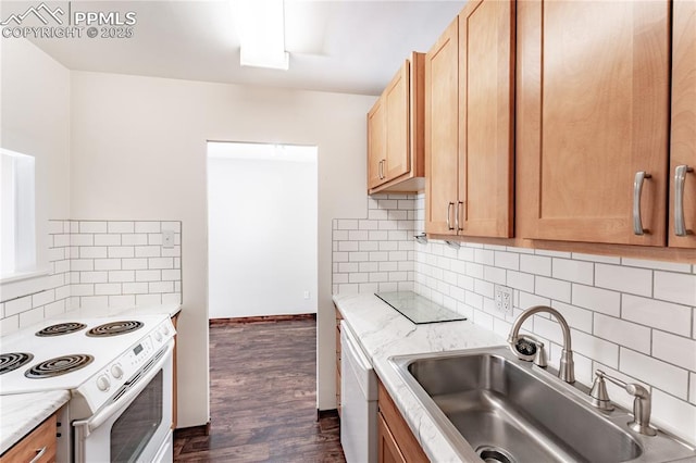 kitchen with dark hardwood / wood-style flooring, sink, white appliances, and backsplash