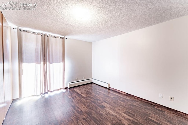 unfurnished room with dark hardwood / wood-style floors, a textured ceiling, and baseboard heating