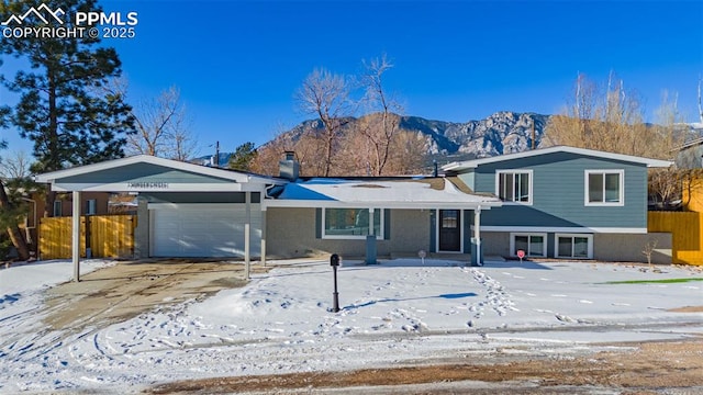 view of front of home with a garage and a mountain view